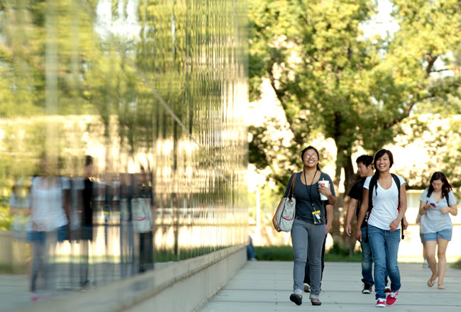 People Walking next to Henry Madden Library 