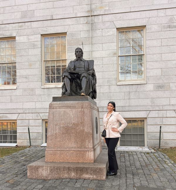 woman standing next to statue