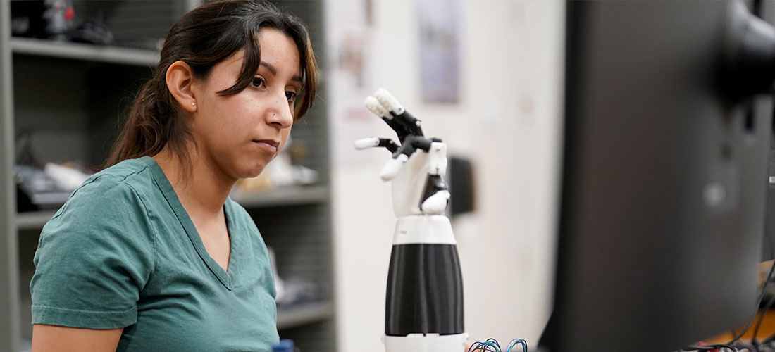 Student designing prosthetic arm
